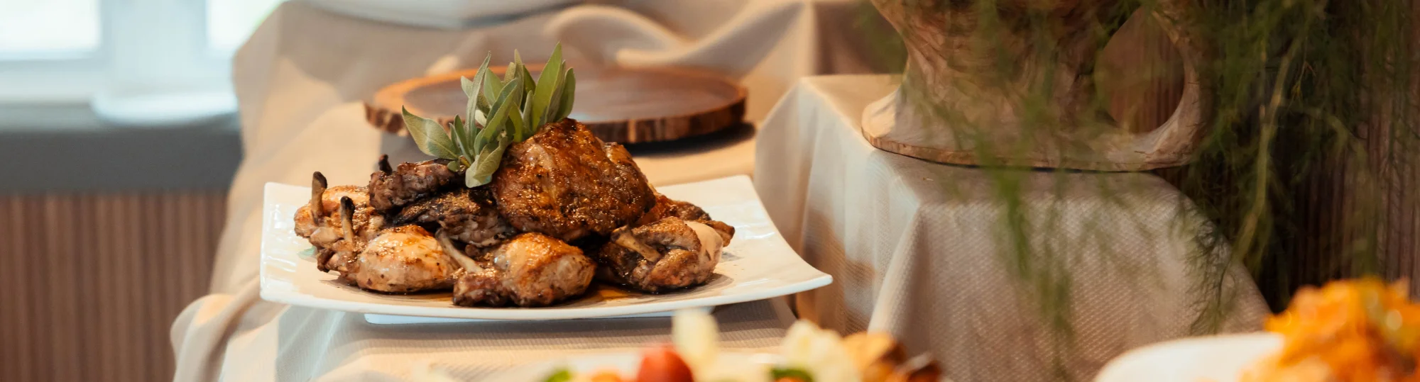 Platter of roasted chicken garnished with herbs